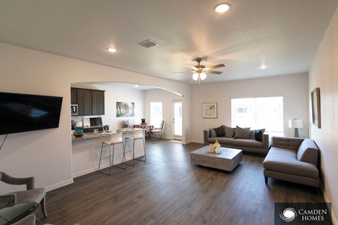 A living room with a television on the wall and a couch.