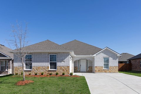 A house with a grey roof and a white door.