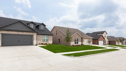 A row of houses with garages in front.
