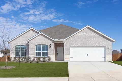 A house with a grey roof and white garage doors.