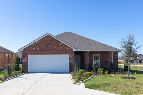 A house with a garage door and a driveway.