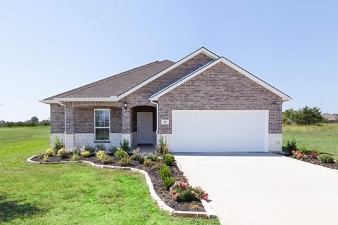 A house with a white garage door and a brick exterior.