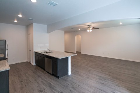 A kitchen area with a sink and a counter.