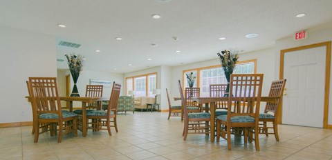 A dining room with a table set for six.