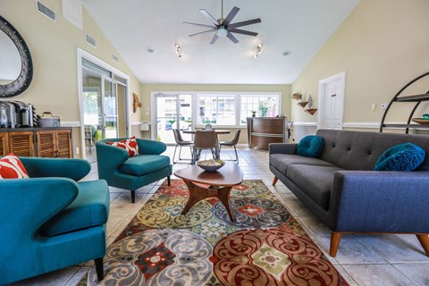 A living room with a grey couch and a blue chair.