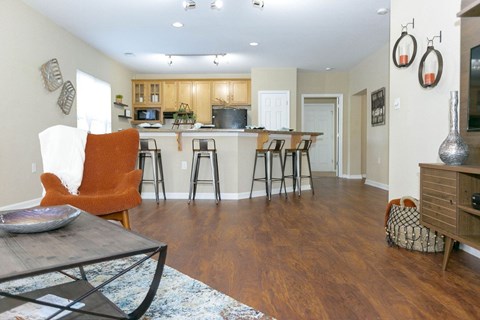 A kitchen with a dining table and chairs.