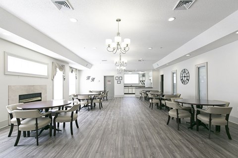 A large dining room with a fireplace and a chandelier.