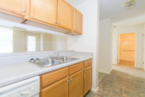 A kitchen with wooden cabinets and a white countertop.