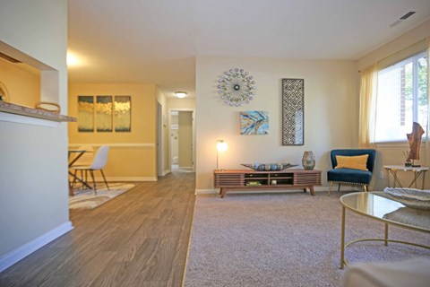 A living room with a white sofa and a grey coffee table.