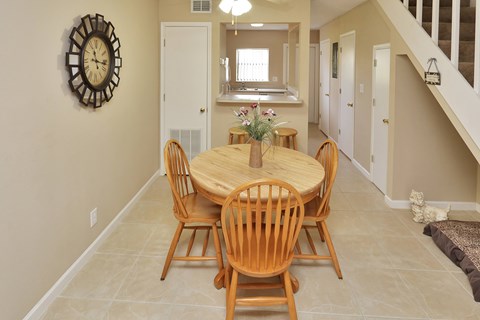 A dining room with a round table and chairs.