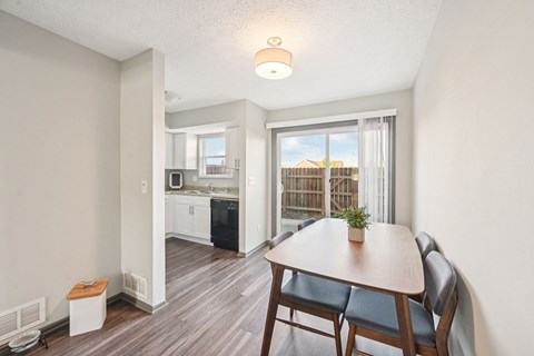 A dining area with a table and chairs is shown.