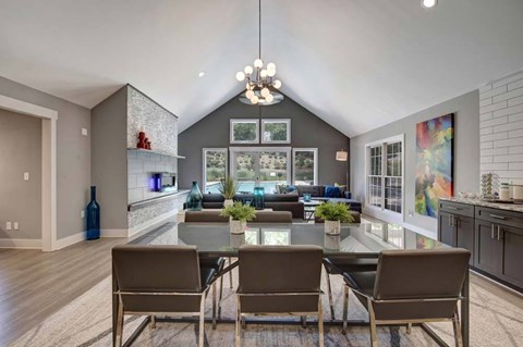 A modern dining room with a glass table and chairs.