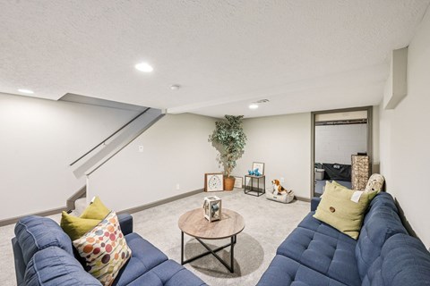 A living room with a blue couch and a coffee table.