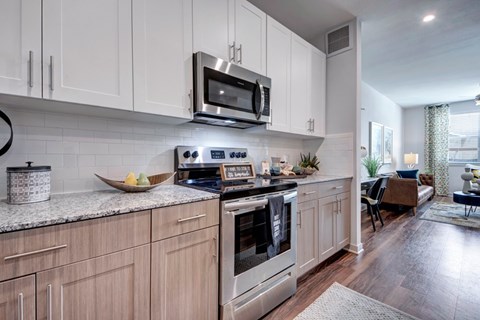 A modern kitchen with wooden cabinets and stainless steel appliances.