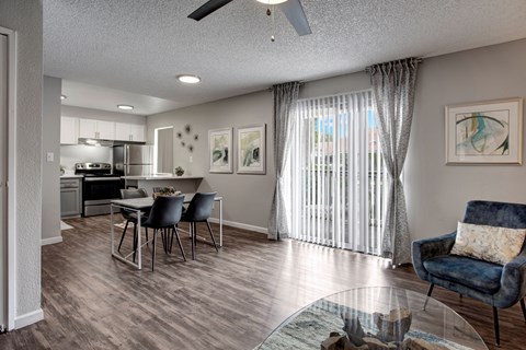 A living room with a dining table and chairs.