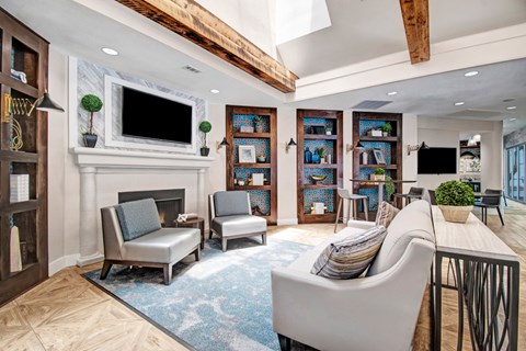 A living room with a fireplace and a television above it.