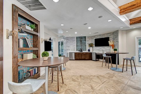 A modern dining room with a wooden table and chairs.