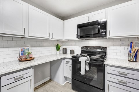 A black stove top oven with a white towel on it.