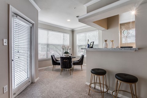 A dining area with a table and chairs.