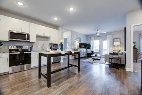 A modern kitchen with a wooden table and chairs.