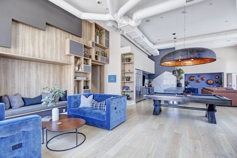 A living room with a blue couch and a coffee table.