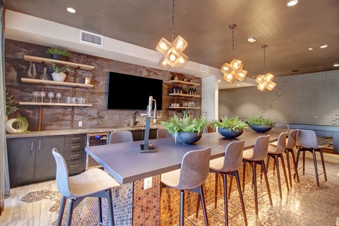 A modern dining room with a large table and chairs.
