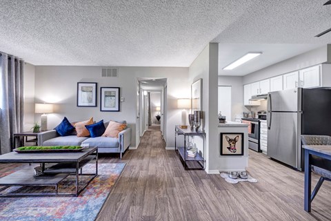 A modern living room with a grey couch and a coffee table.