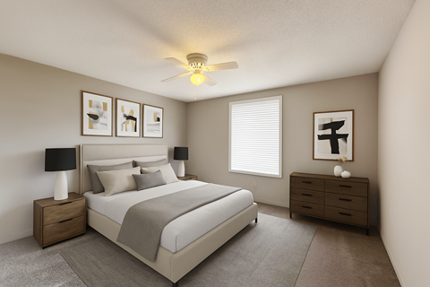 A bedroom with a bed, nightstand, and a ceiling fan.