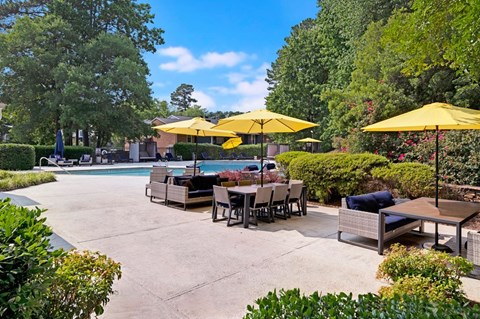 A poolside area with a table set for dining.