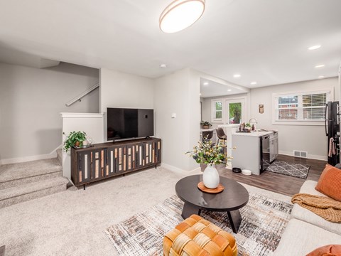A living room with a television, a couch, and a coffee table.