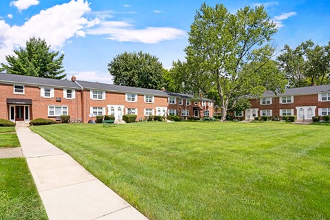 A grassy area in front of apartment buildings.