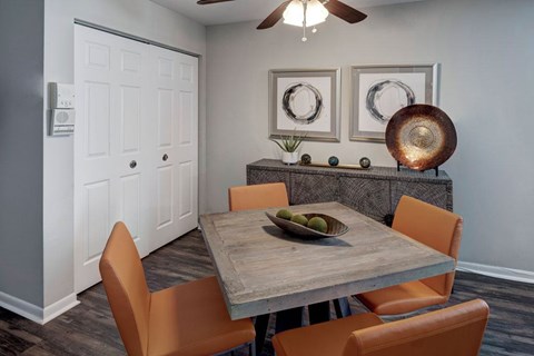 A dining room with a table and chairs.