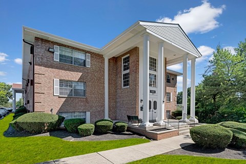 A building with a white porch and a covered entrance.
