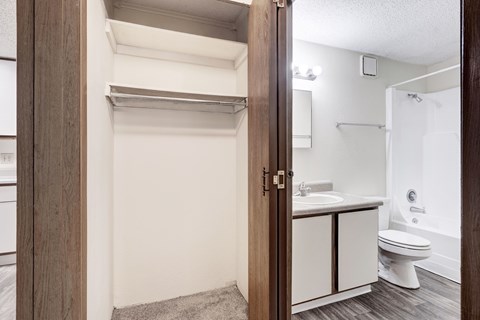 A bathroom with a toilet, sink, and a mirror.