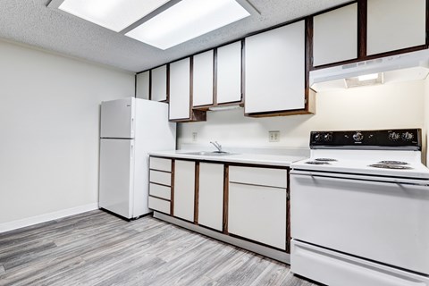 A kitchen with white appliances and cabinets.