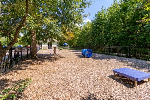 A playground with a slide, swings, and a bench.