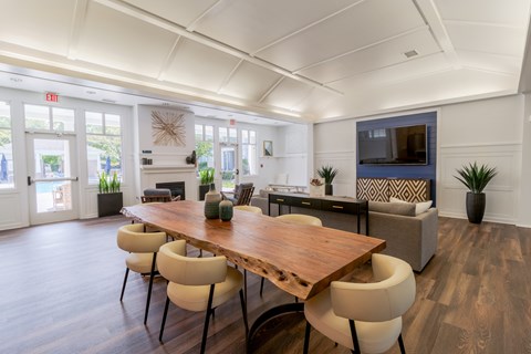 A dining room with a wooden table and chairs.