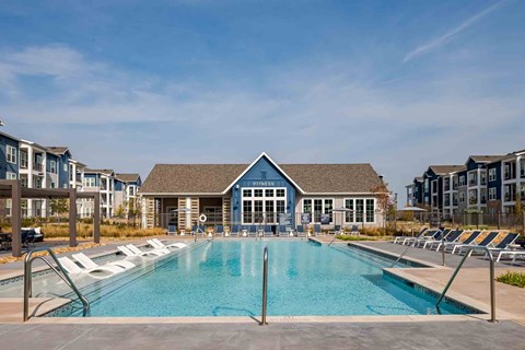 A large swimming pool in front of a building with the word "FINISHER" on it.