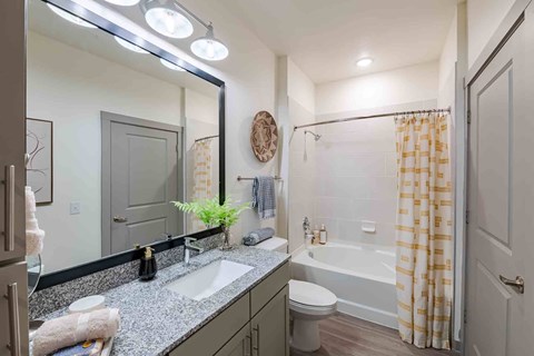 A bathroom with a sink, toilet, and bathtub.