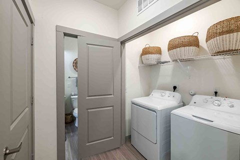 A small laundry room with a washer and dryer.