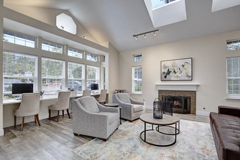 A living room with a fireplace and a painting on the wall.