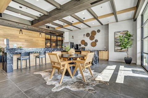 A modern dining room with a wooden table and chairs.