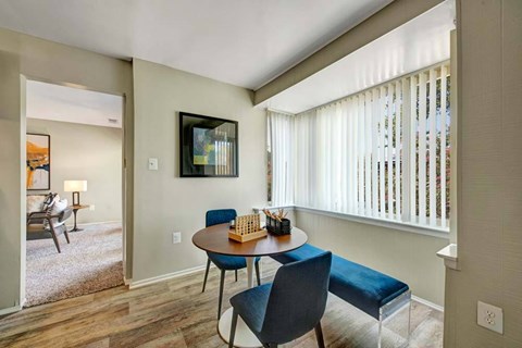A dining room with a table and chairs.