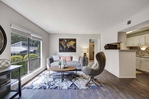 A living room with a grey armchair and a coffee table.