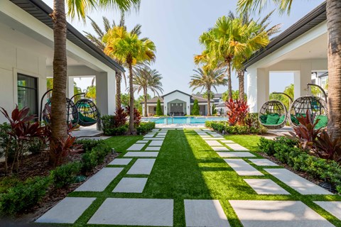 A garden with a white and green striped pathway.