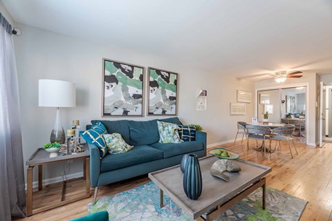 A living room with a blue couch and a coffee table.
