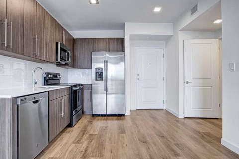 A kitchen with wooden cabinets and stainless steel appliances.