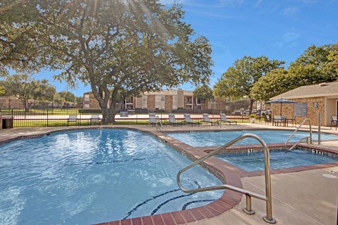 A large outdoor swimming pool with a metal ladder.