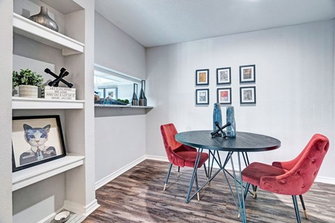 A room with a round table and chairs.