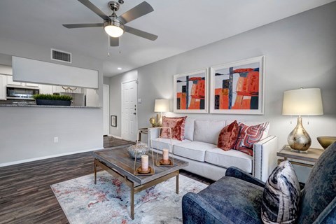 A living room with a white couch and a coffee table.